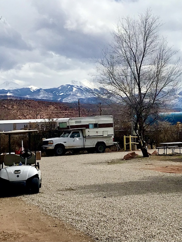 Truck camper by the mountains as an example of What Type of RV is Best for You?