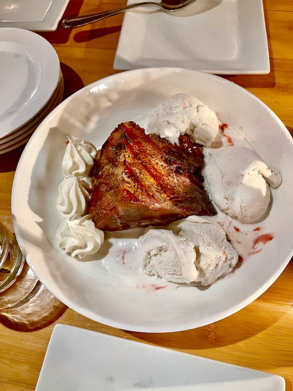 Large white bowl filled with bread pudding and vanilla ice cream at Bimini Twist