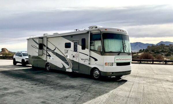Large motorhome towing a white Jeep after following the procedure in RV Setup and Teardown Checklist Part 2