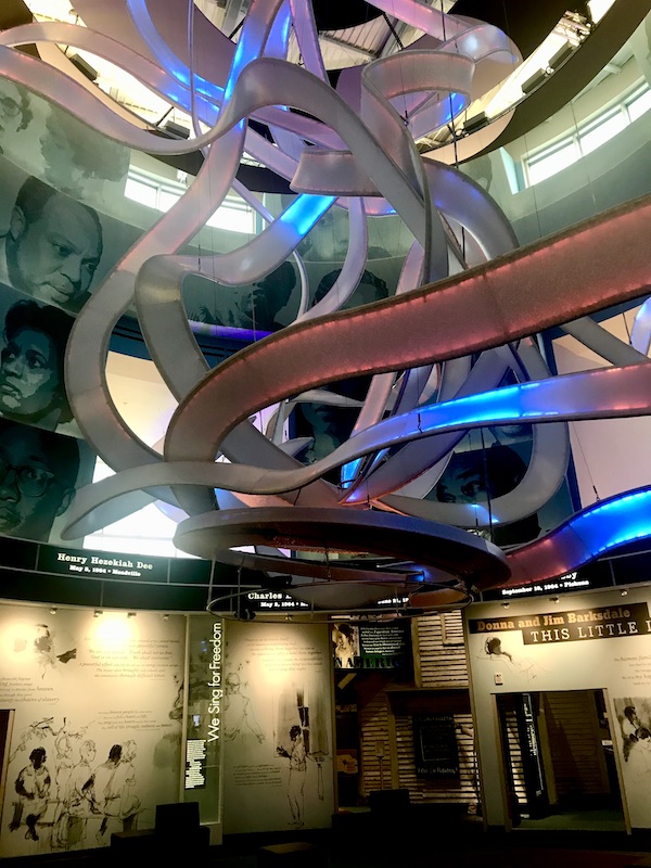A glass ribbon sculpture changes colors to the music at the Mississippi Civil Rights Museum in Jackson MS. Part of my 3 Years RVing Year 1 Recap