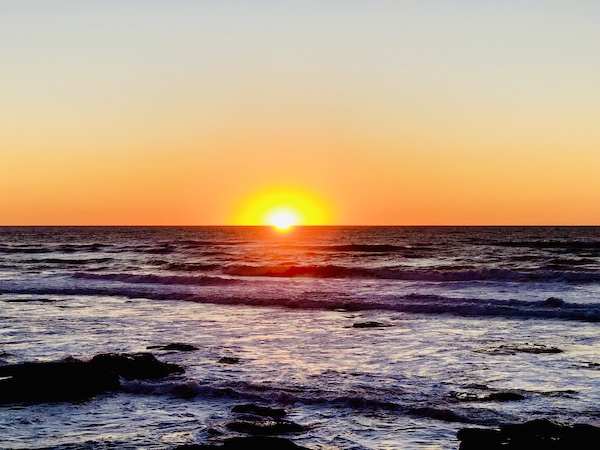 Inky ocean with bright yellow sun at the horizon in San Diego CA. Part of my 3 Years RVing Year 1 Recap