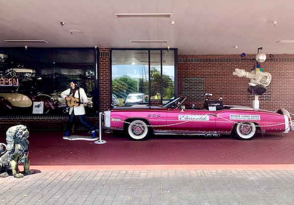 Hot pink Cadillac convertible and a statue of Elvis welcome all to the antique car museum in Tallahassee Florida