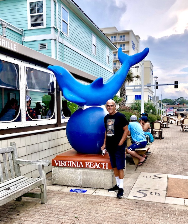 Blue dolphin sculpture and Steve in Virginia Beach, VA. Part of my 3 Years RVing Year 1 Recap