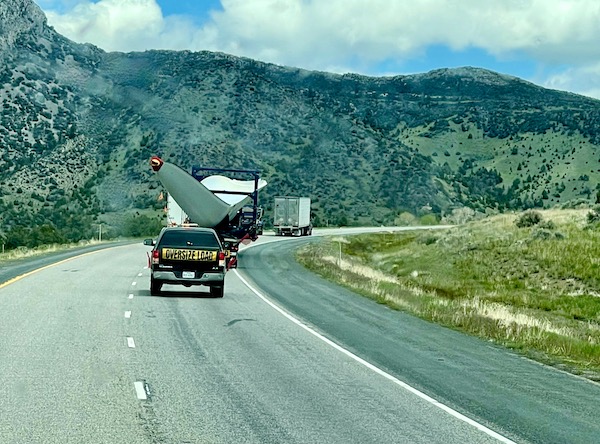 An enormous windmill blade on a flat bed truck being hauled down the highway. 3 Years RVing Year 3 Recap