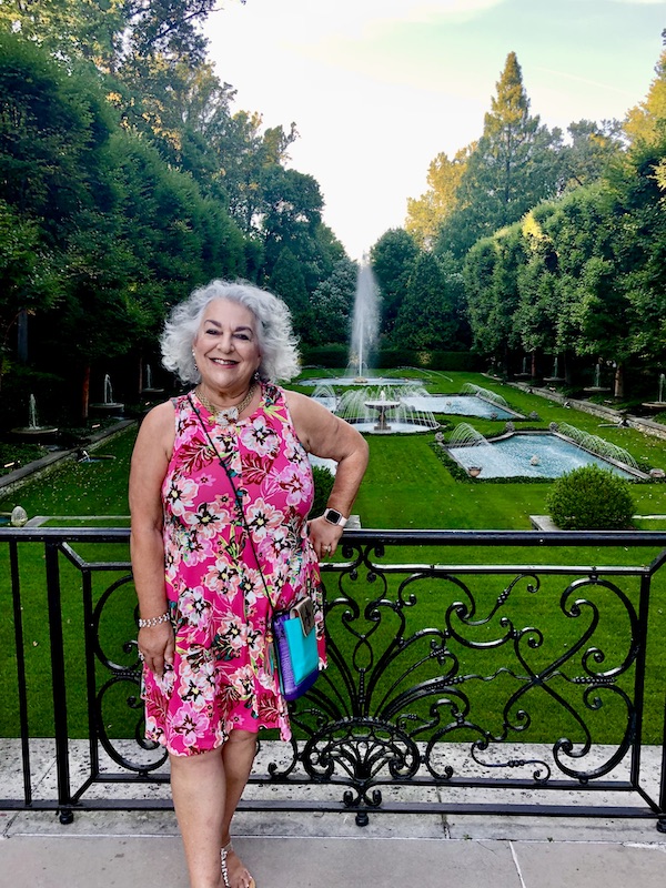 Me in a pink dress standing in front of the Italian Water Gardens. Part of my 3 Years RVing Year 3 Recap