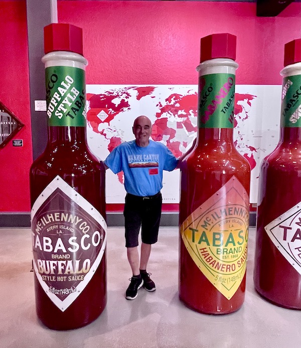 Steve standing between 2 ginormous bottles of Tabasco that are taller than he is by at least a foot! Part of my 3 Years RVing Year 3 Recap