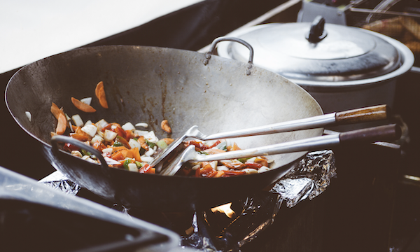 The art of Chinese Cuisine: understanding the basics - Wok filled with stir fry ingredients on a gas stove.