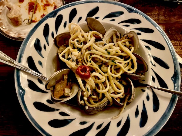 Painted pasta bowl filled with linguine and clams with chile peppers at Elisabetta's Ristorante Bar Pizzeria