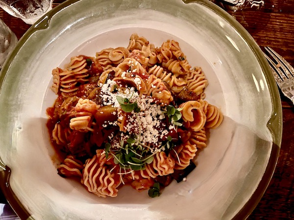 Shallow pasta dish filled with radiator shaped short pasta, red sauce and eggplant from Elisabetta's Ristorante Bar Pizzeria