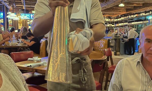 Man grating cheese onto our dishes at Elisabetta's Ristorante Bar Pizzeria
