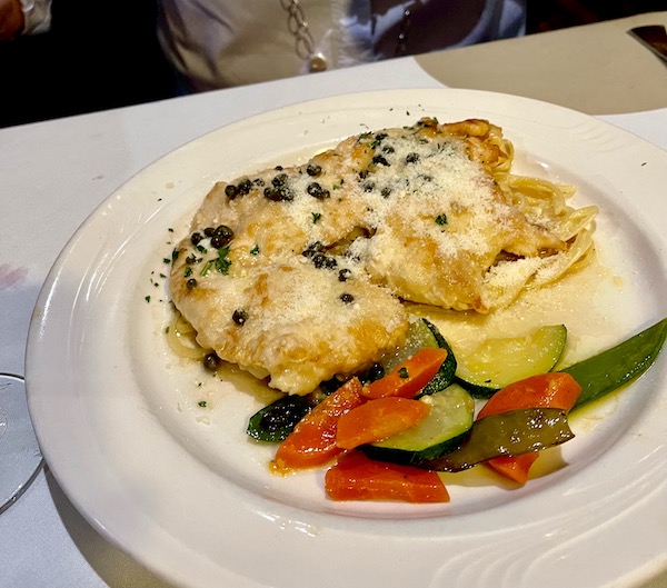 Thin slices of egg battered chicken breast with creamy sauce and veg medley at Stresa Italian Restaurant WPB FL