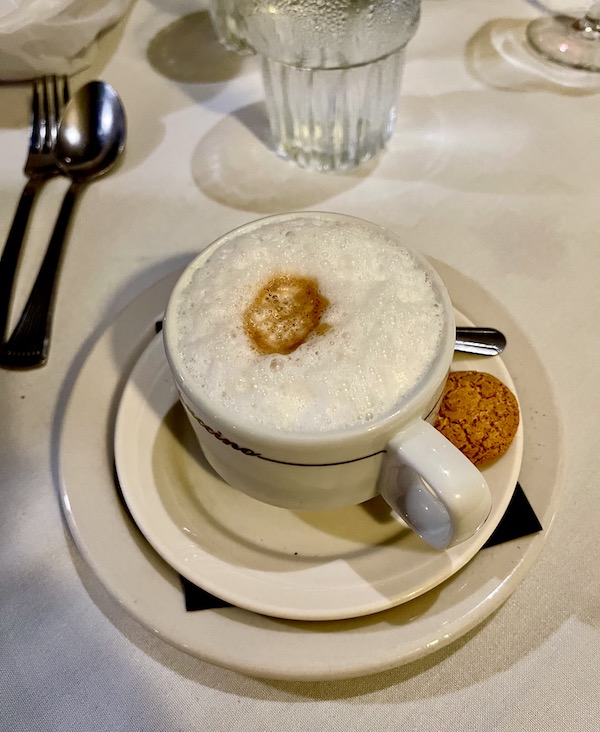 Cup of frothy cappuccino and a cookie at Stresa Italian Restaurant WPB FL
