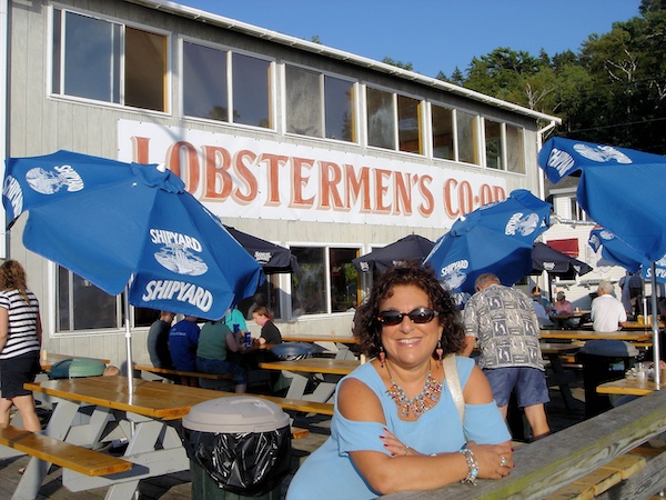 Me in light blue, leaning on a rail in front of a lobster shack.