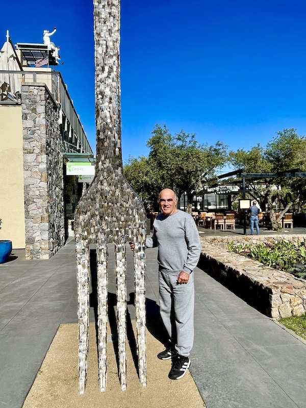 Steve standing next to an enormous fork made of 100s of regular forks.