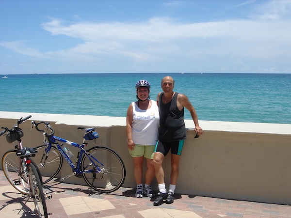 Us by the sea wall in Palm Beach, resting from cycling.