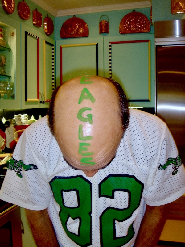 Steve showing off his head painted with Eagles in green lettering.