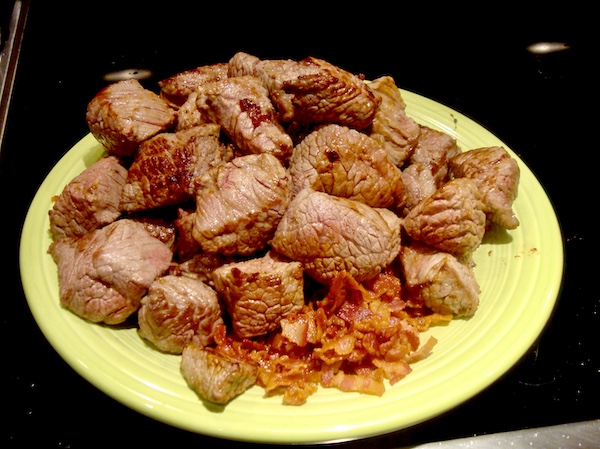 Homage to Julia Child green topped with seared beef cubes and cooked bacon for her Boeuf Bourguignon recipe