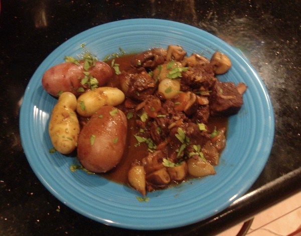 Blue plate topped with beef, potatoes, and vegetables in my Homage to Julia Child
