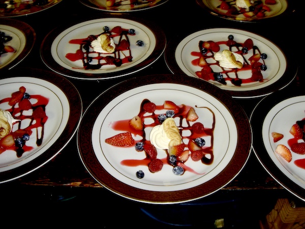 I Love to Feed People colorful plated desserts on a black tablecloth