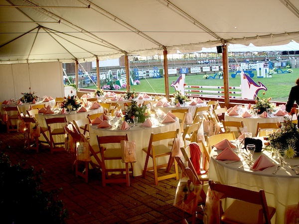 I Love to Feed People under a tent at beautifully set tables at an equestrian event.