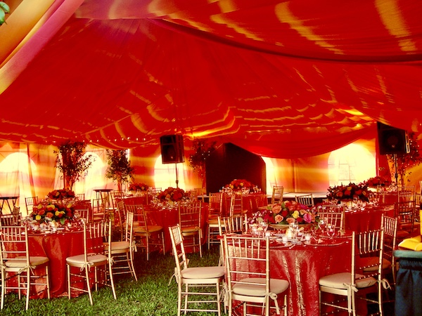 I Love to Feed People under orange tie dye draped tents.