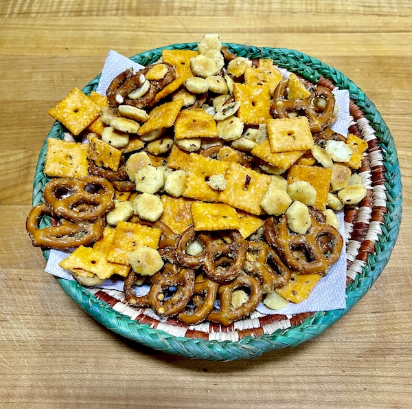 I Love to Feed People bar snacks in a basket on wood board