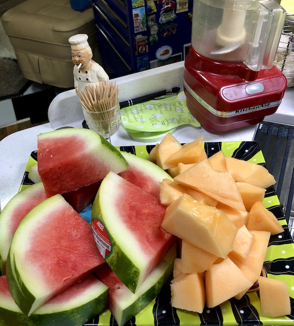 I Love to Feed People cut up watermelon and cantaloupe sitting on our kitchen counter.