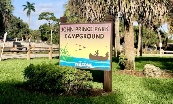 Painted sign welcoming you to John Prince Park Campground Lake Worth FL