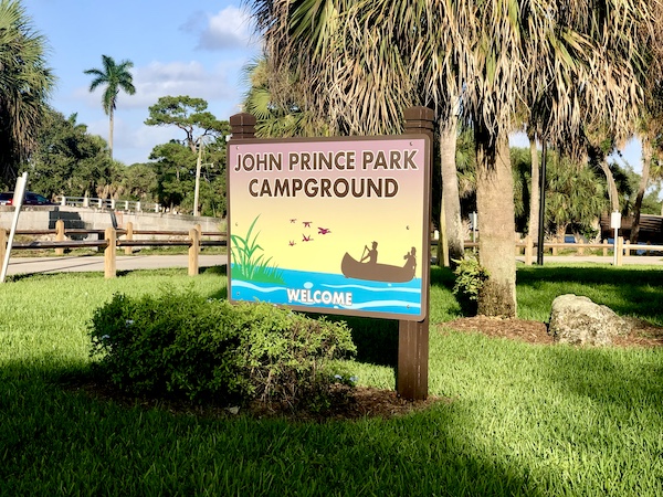 Painted sign welcoming you to John Prince Park Campground Lake Worth FL