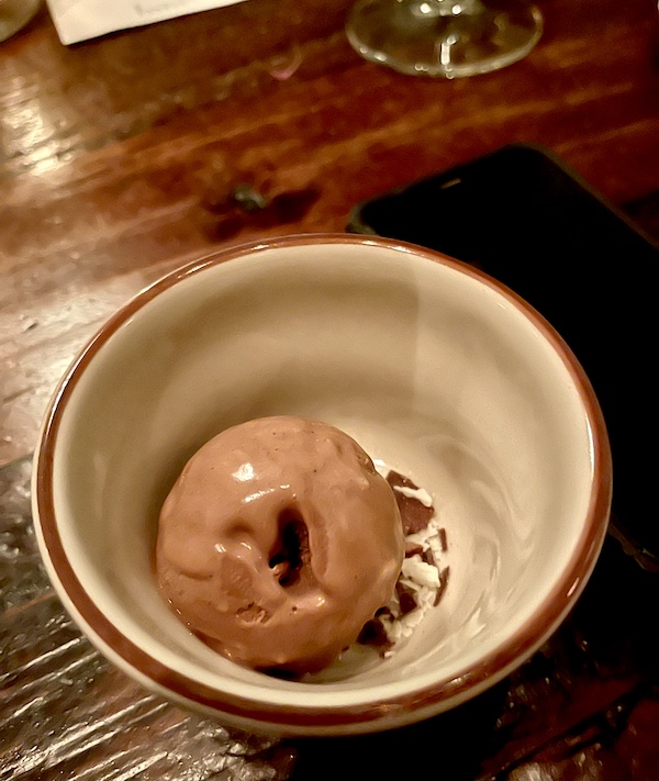 Small red rimmed bowl with a scoop of chocolate ice cream at Five and Ten Athens GA