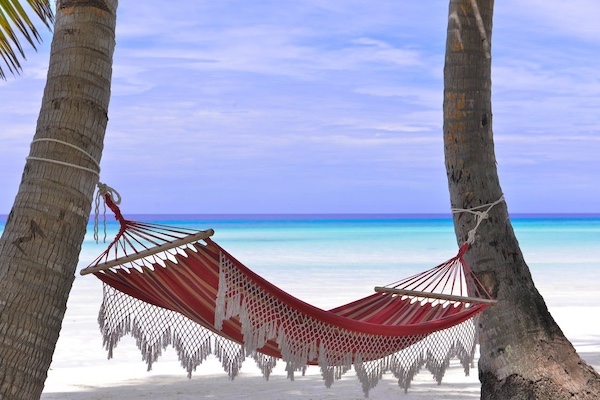 Barbados Bound: Guide to Ultimate Girl Gang Getaway hammock at the beach with sand and ocean.