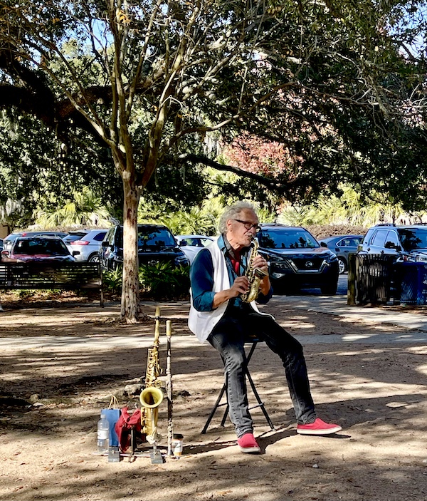 Man playing a saxophone at Café du Monde City Park NOLA