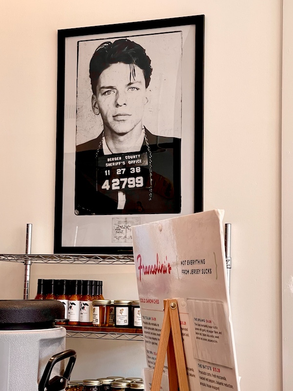 At Francolini's Italian Deli NOLA this black and white arrest photo of Frank Sinatra hangs on the wall.