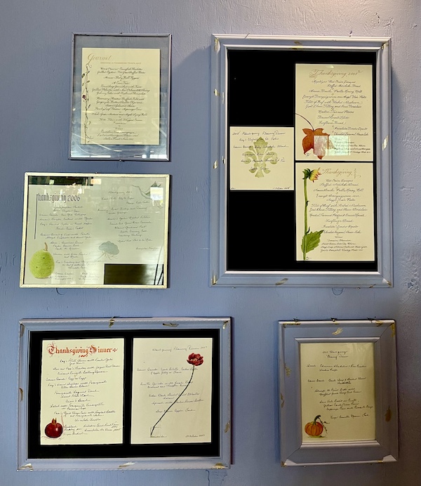 Grouping of hand created menus on a lavender wall at SoFab NOLA is So Fabulous!
