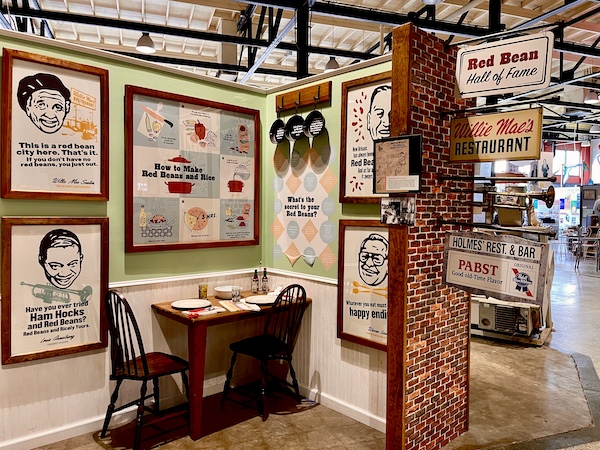 Framed photos and a table for two highlighting red beans at SoFab NOLA is So Fabulous!