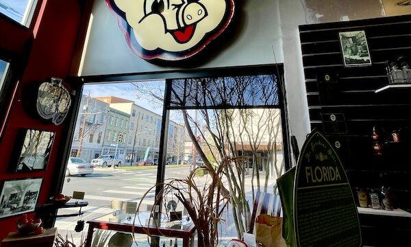 Neon Piggly Wiggly sign above a front window at SoFab NOLA is So Fabulous!