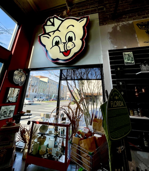 Neon Piggly Wiggly sign above a front window at SoFab NOLA is So Fabulous!