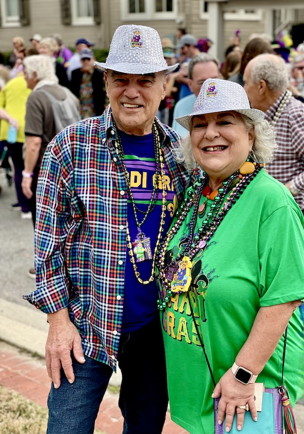 Steve and I in Mardi Gras Ts and white fedoras at the block party that is a 52 Year Mardi Gras Tradition