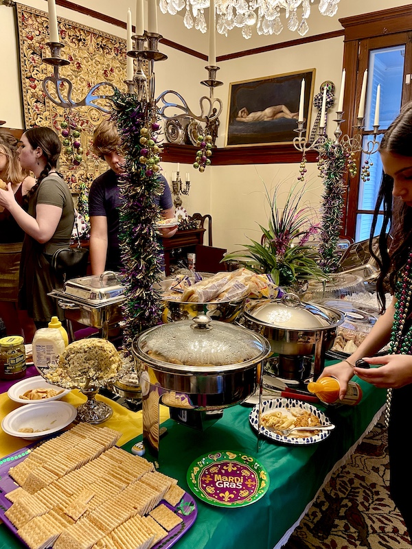 Dining table in a large home laden with food for crowd.