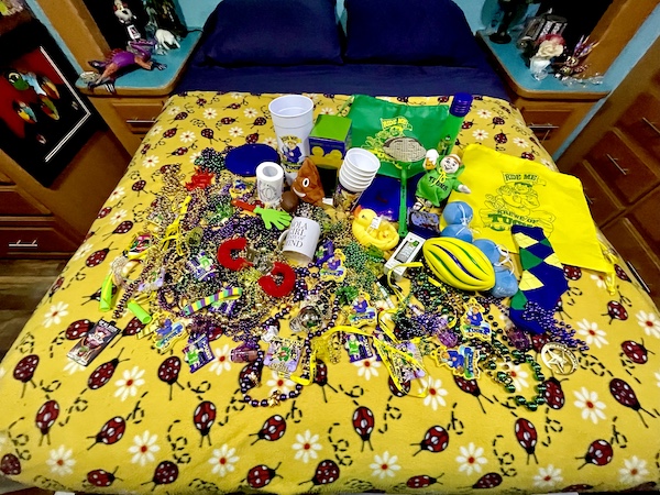 After a 52 Year Mardi Gras Tradition our bed is topped with tons of beads and trinkets from a Mardi Gras parade