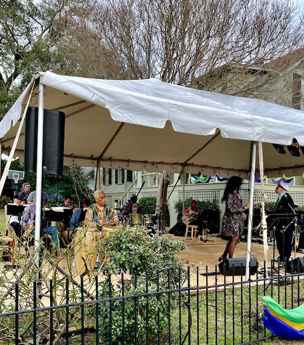 Group of musicians performing under at tent at a 52 Year Mardi Gras Tradition