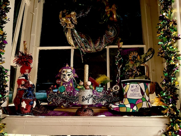 Masks and trinkets adorn a window ledge at a restaurant in NOLA