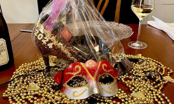 Mardi Gras State of Mind with this years Muses Mardi Gras shoe and beads on a dining room table