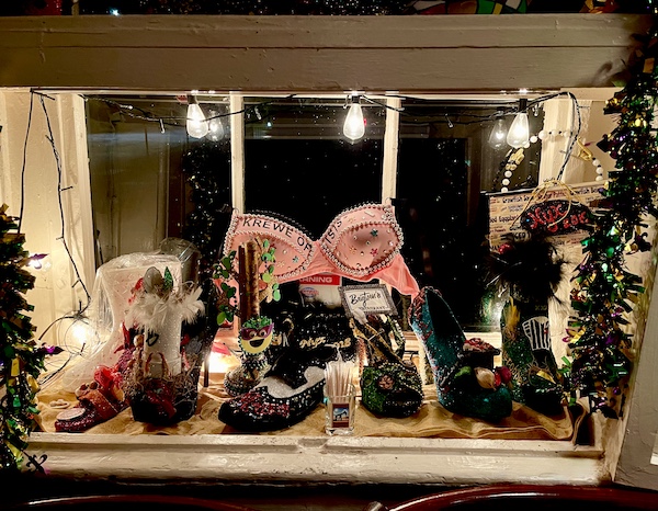 Mardi Gras State of Mind shoes, decorated bra and other trinkets on display