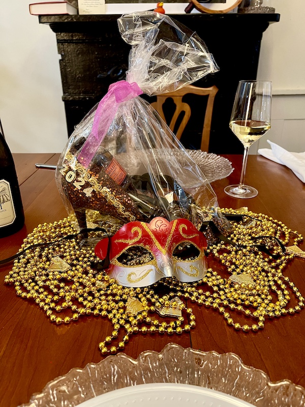 Mardi Gras State of Mind with this years Muses Mardi Gras shoe and beads on a dining room table