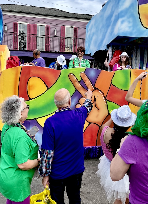 As a colorful float passes Steve and I are catching beads at Our First Mardi Gras Parade