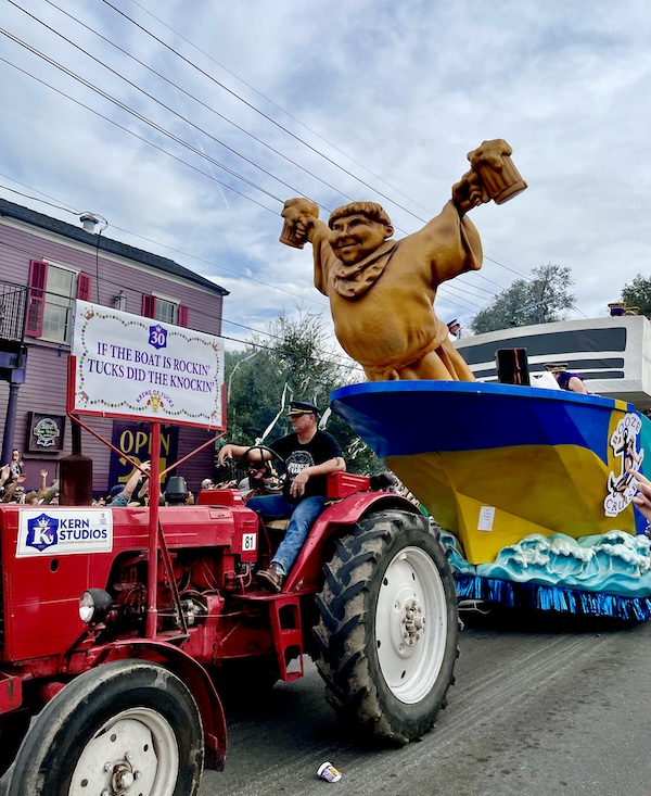 Large Friar Tuck statue adorns the bow of a float that looks like a cruise ship on the ocean at Our First Mardi Gras Parade