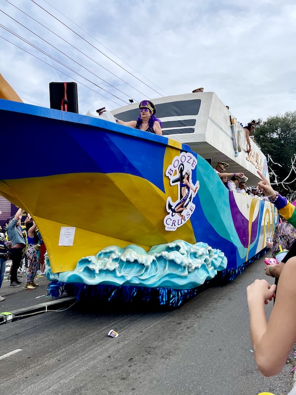 At Our First Mardi Gras Parade a float that looks like a cruise ship on the ocean