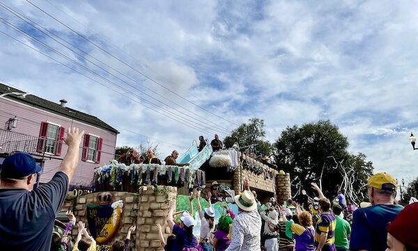 Our First Mardi Gras Parade old English themed float with large tub and men dressed as Friars throwing beads