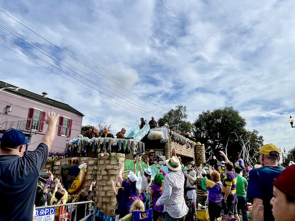 Our First Mardi Gras Parade old English themed float with large tub and men dressed as Friars throwing beads